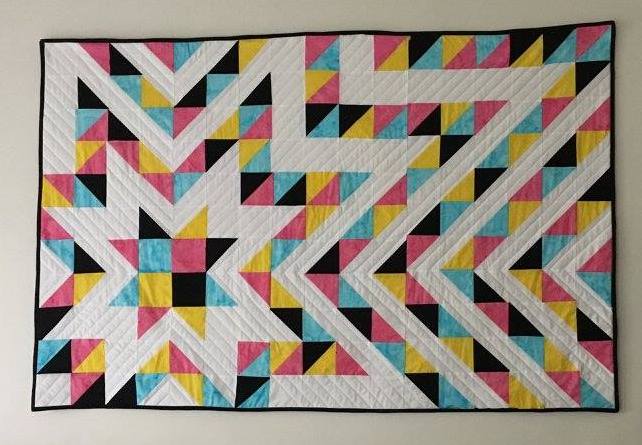 Starburst wall quilt in CMYK color scheme