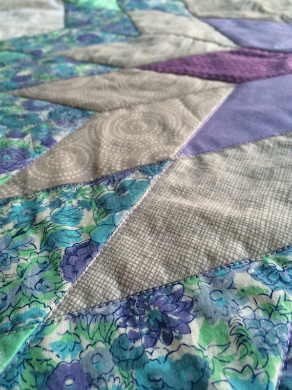 White, teal, and lavendar Lone Star quilt